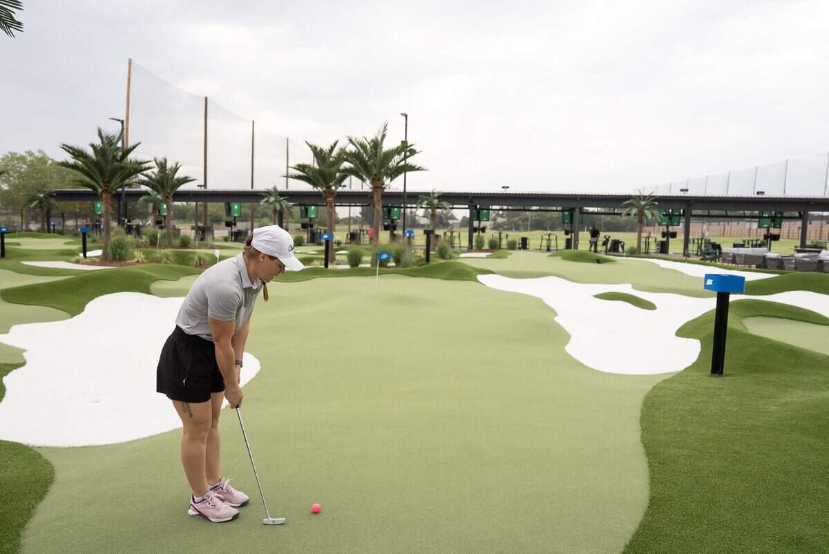 Sheila Atchison, Director of Team Development for Mammoth Clubhouse, demonstrates hitting from one of their bays. Mammoth Clubhouse is located at 950 N. Webb Rd. at the former All Star Adventures property.